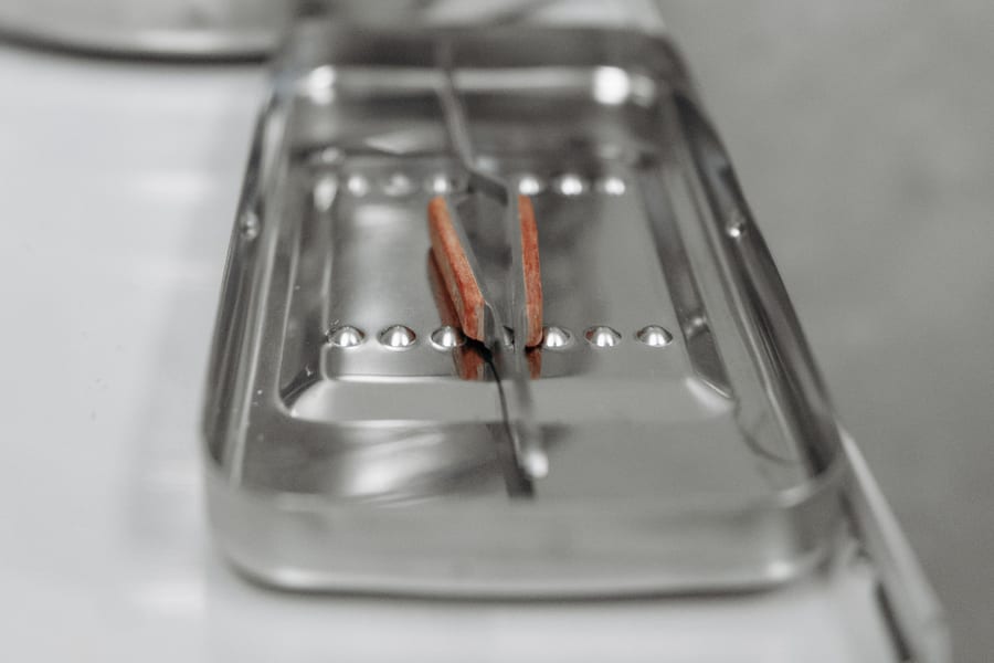 Close-up of sterilization indicator strips on a metal instrument tray