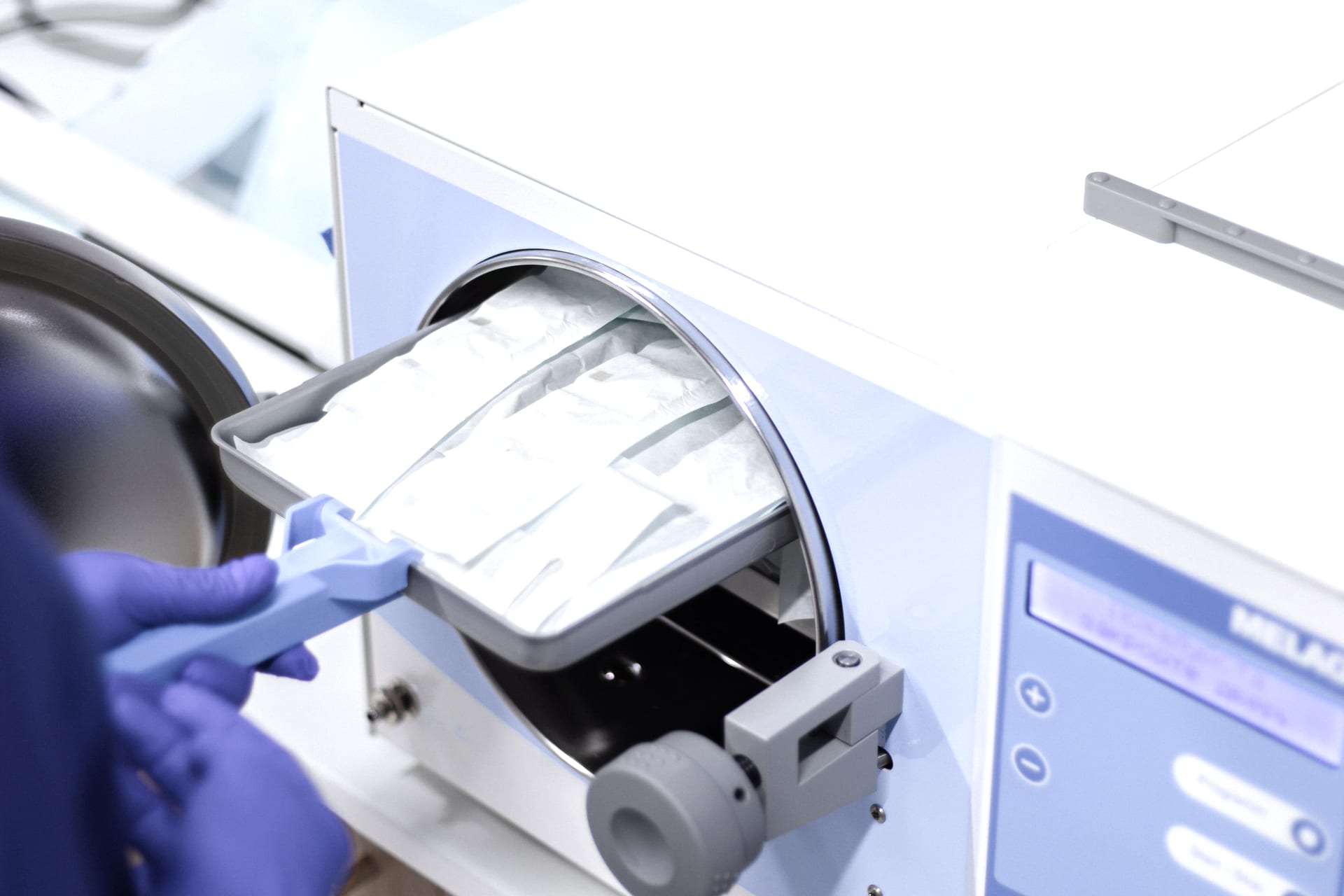 Healthcare professional operating sterilization equipment
